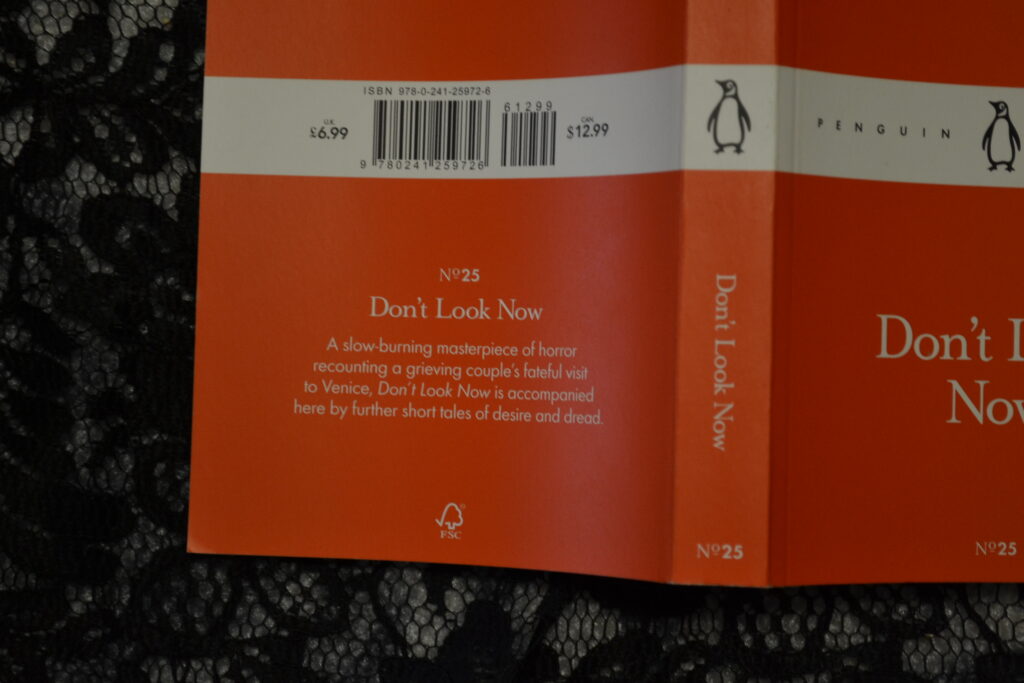 The orange cover of Don't Look Now on black lace.