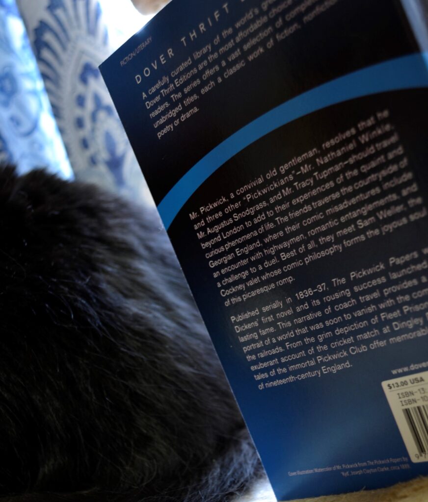 The back copy of The Pickwick Papers with a black cat in the background.