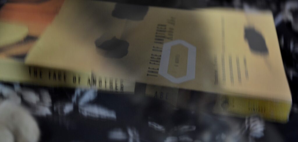 A blurred picture of the yellow cover of The Face of Another.