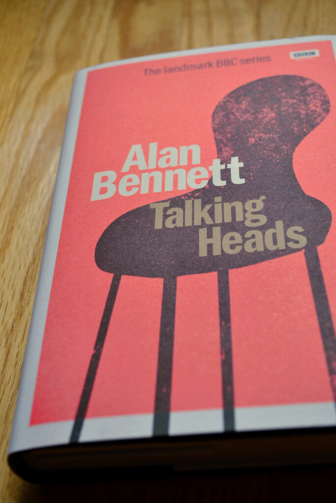 The front cover of Talking Heads is orange with a white border, featuring the silhouette of a chair.