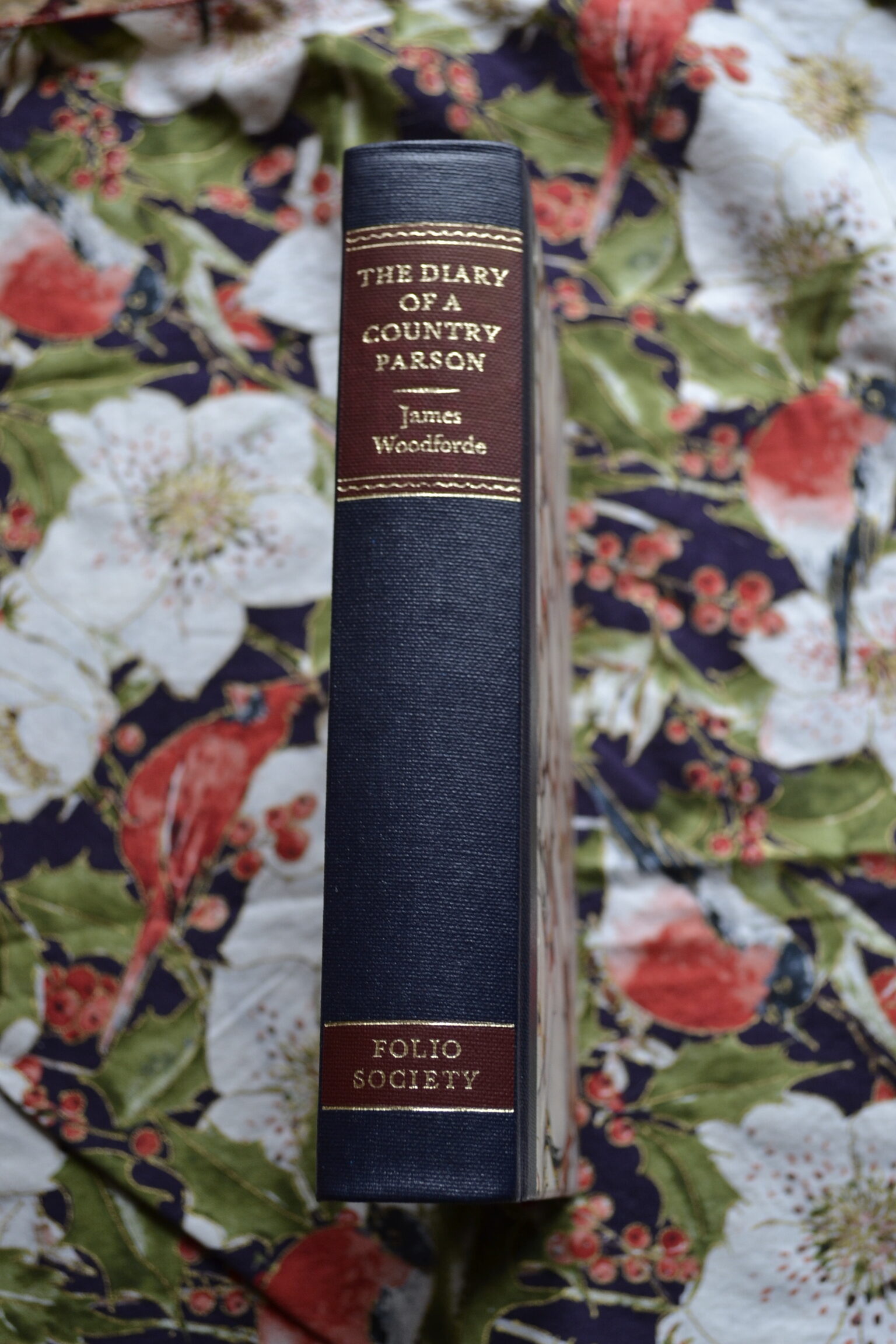 The blue spine of a book reads 'The Diary of a Country Parson' in gold letters.