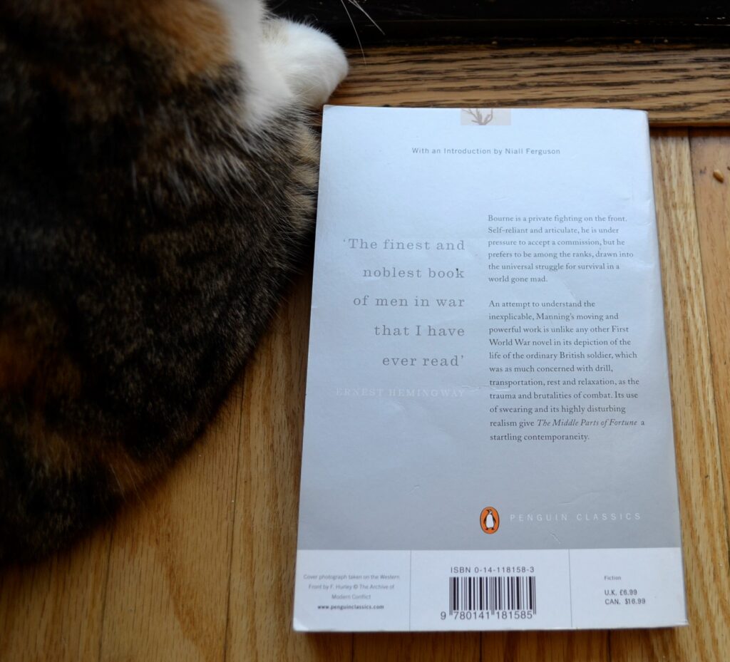 The silver back cover beside a white paw reads, 'The finest and noblest book of men in war that I have ever read.'