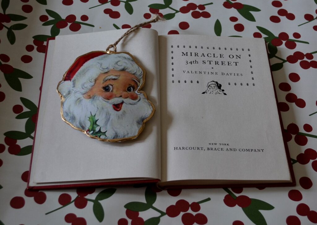 The title page is held open by an ornament and reads Miracle on 34th Street.