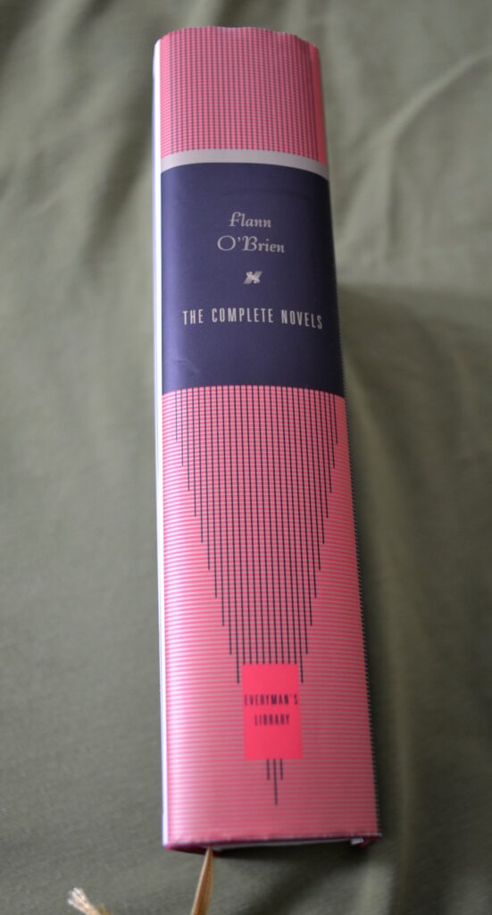 The red spine of a book reads 'Flann O'Brien — The Complete Novels'.