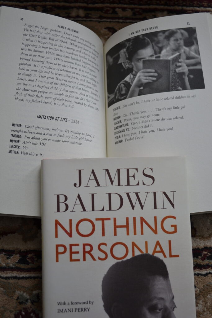 A book with script text and an image of a girl reading is held open by the cover of Nothing Personal.