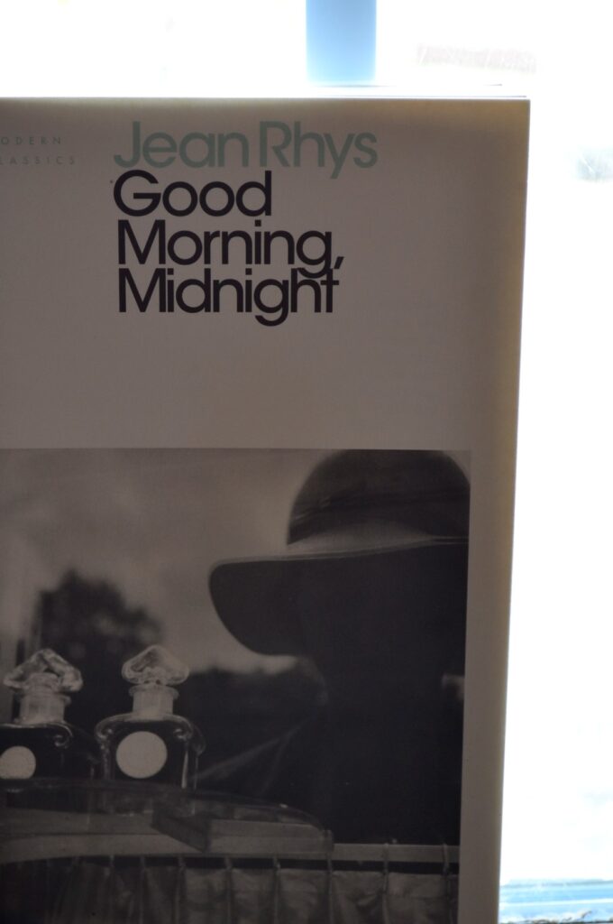 A book with a blurry black-and-white photo of a woman is titled Good Morning, Midnight.