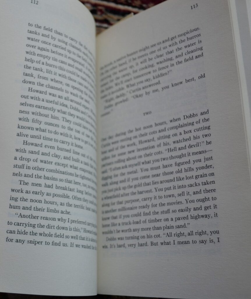 A book is open to page 112 and 113, the beginning of Chapter Two.