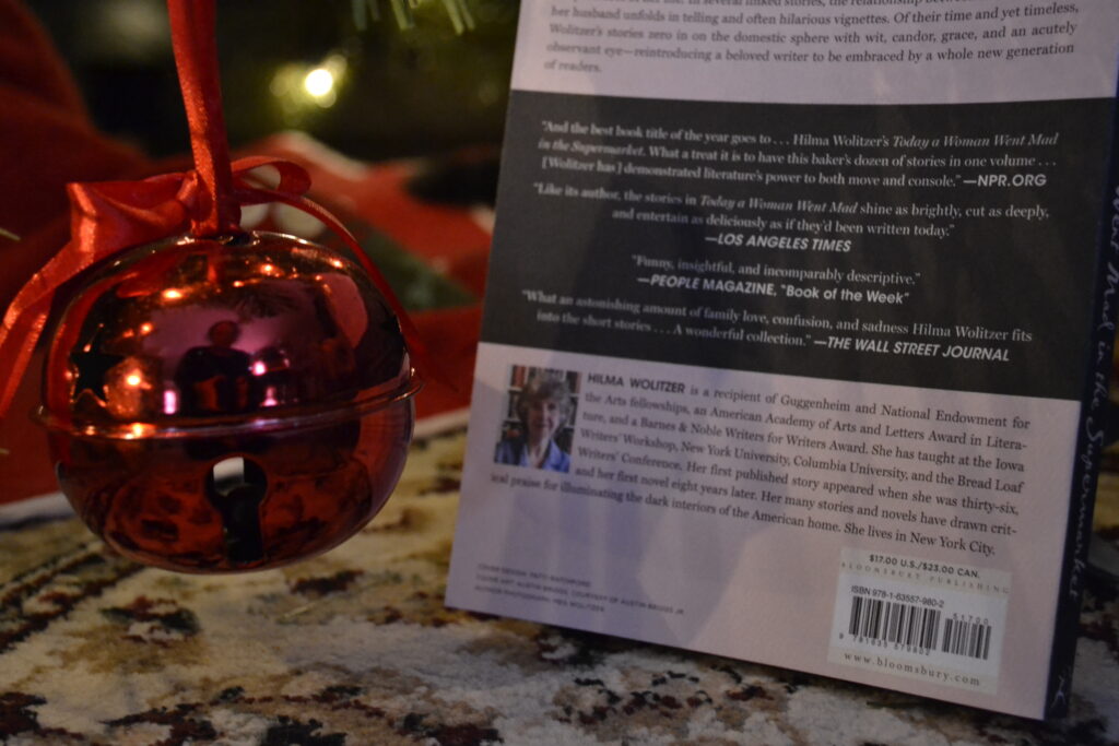 A big red bell hangs beside a pink book by Hilma Wolitzer.