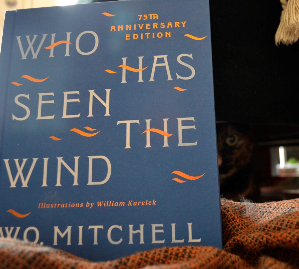 A blue book with gold wind marks on it proclaims itself to be Who Has Seen the Wind, a 75th anniversary edition.