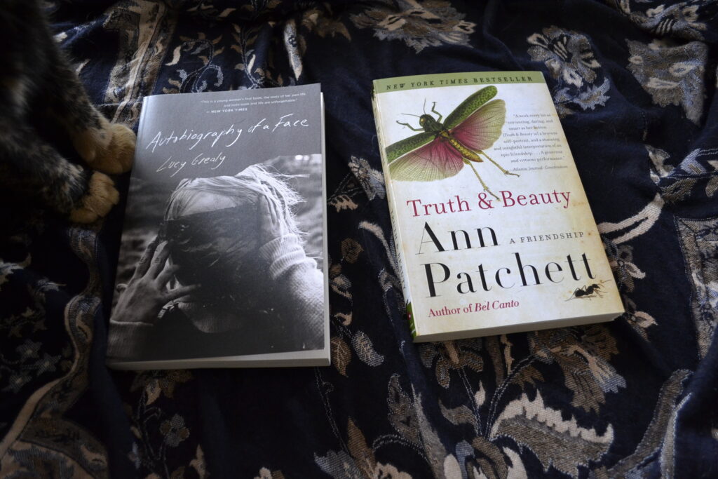 A pair of paws can be see beside two books: Grealy's Autobiography of a Face and Patchett's Truth & Beauty.