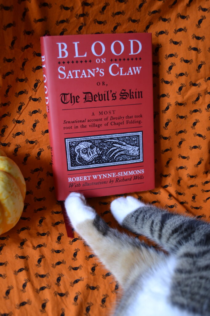 Blood on Satan's Claw by Robert Wynne-Simmons is a red book with illustrations by Richard Wells.
