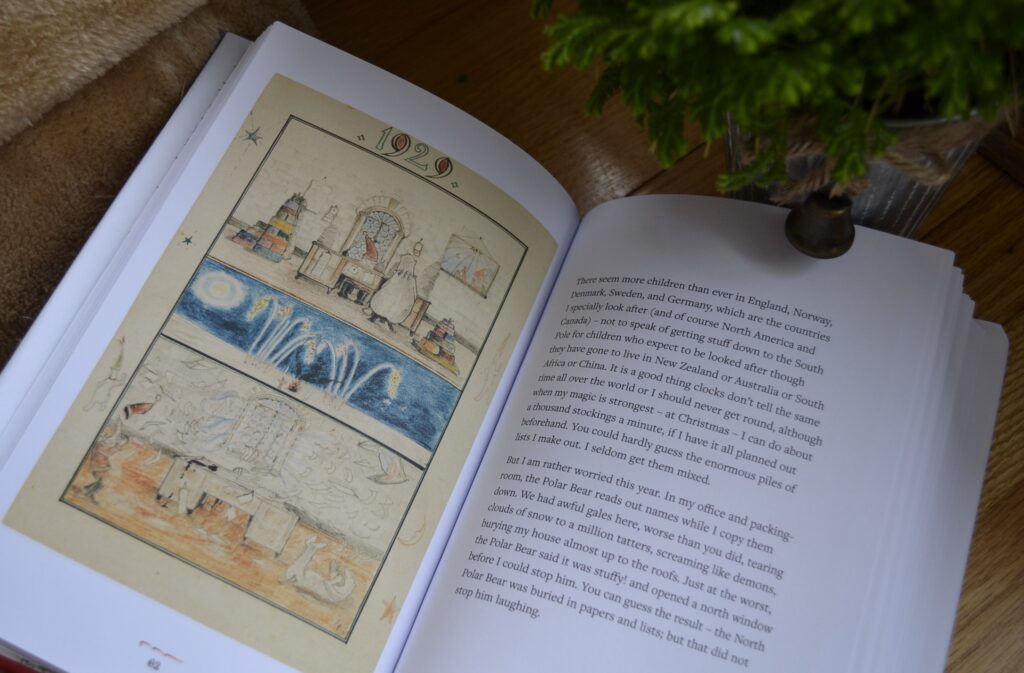 A book is open to an illustrated page featuring images of the North Pole and Father Christmas' magical life.