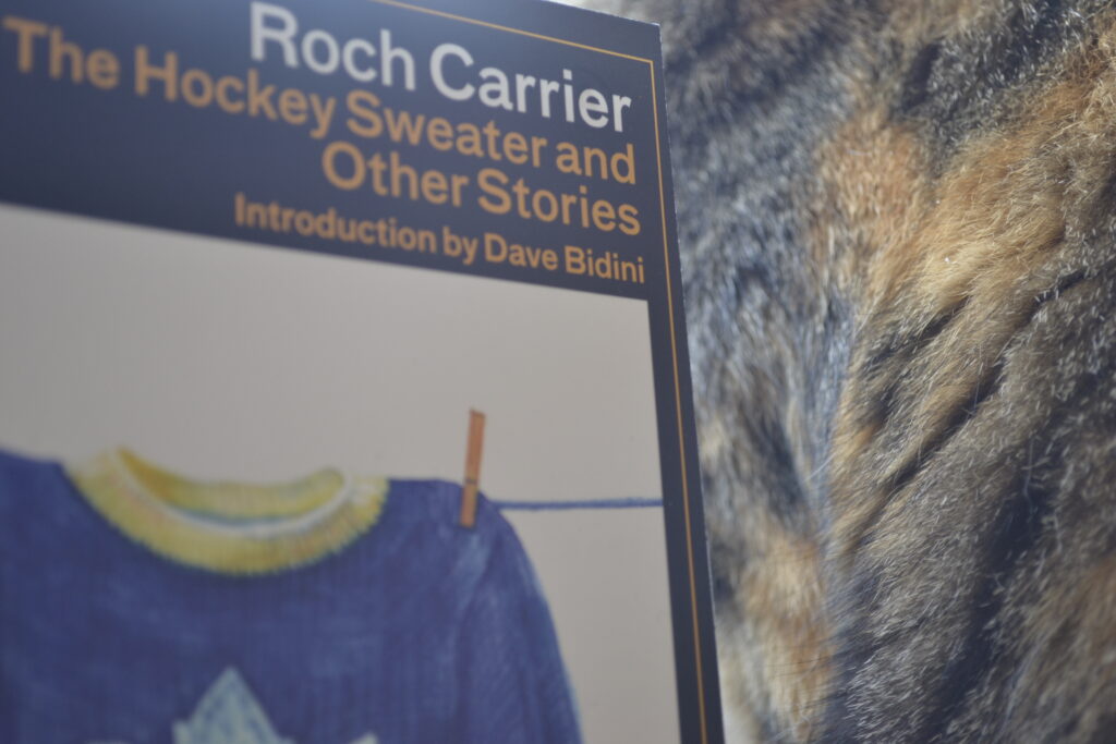 Roch Carrier's The Hockey Sweater and Other Stories has a cover with a drawing of a blue and white Maple Leafs sweater pinned to a clothesline.