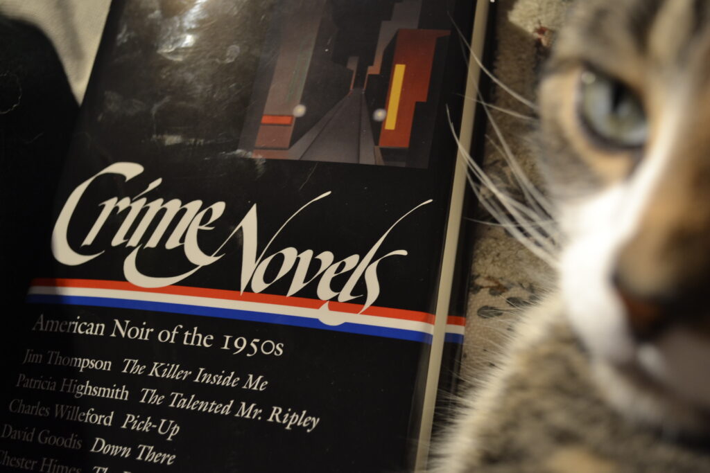 Crime Novels: American Noir of the 1950s leans against a sleek cat.