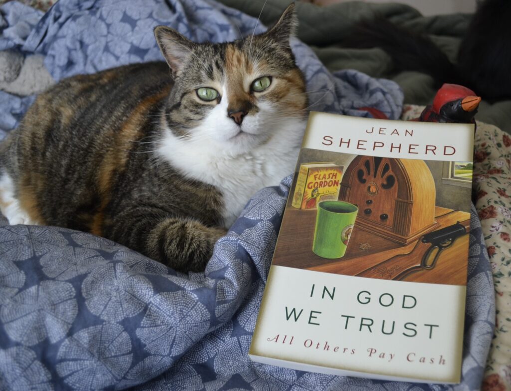 The cover of Jean Shepherd's book In God We Trust: All Others Pay Cash has a vignetting fade on the edges and an inset drawing of an antique radio.