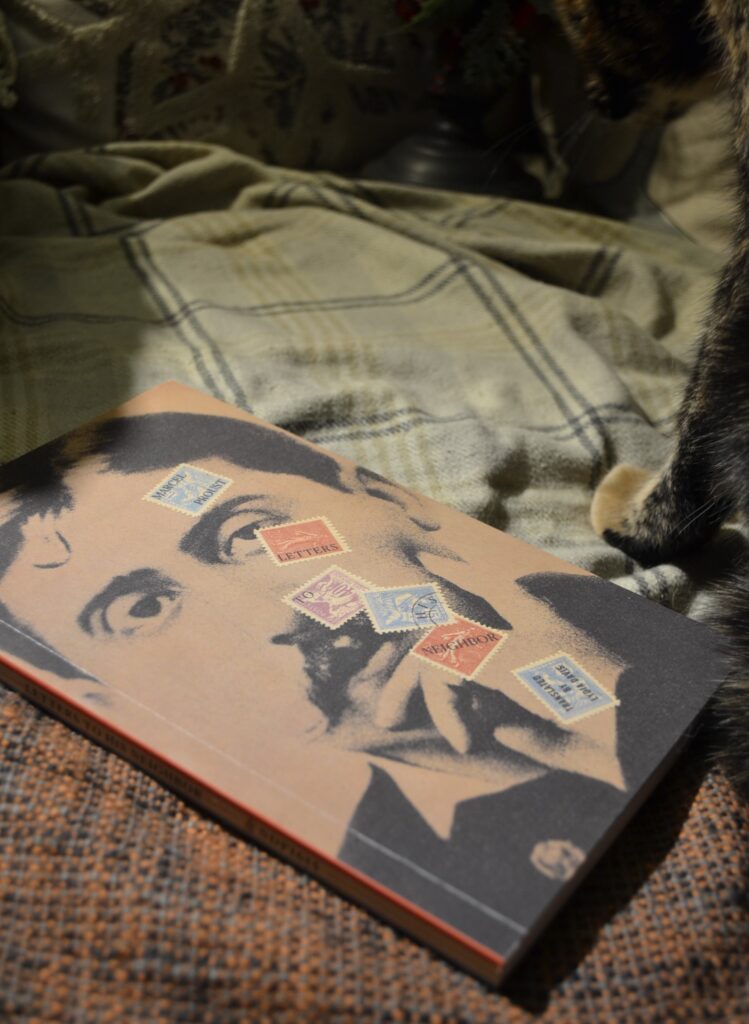 Marcel Proust's Letters to his Neighbour lies beside the paws of a tortie cat.