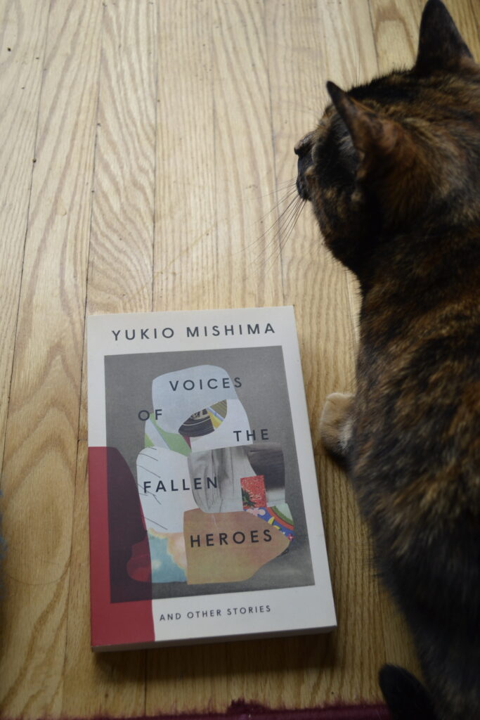 Yukio Mishima's Voices of the Fallen Heroes and Other Stories is a paperback book with a collage cover showing bits of Japanese paper and images and a red-covered corner.