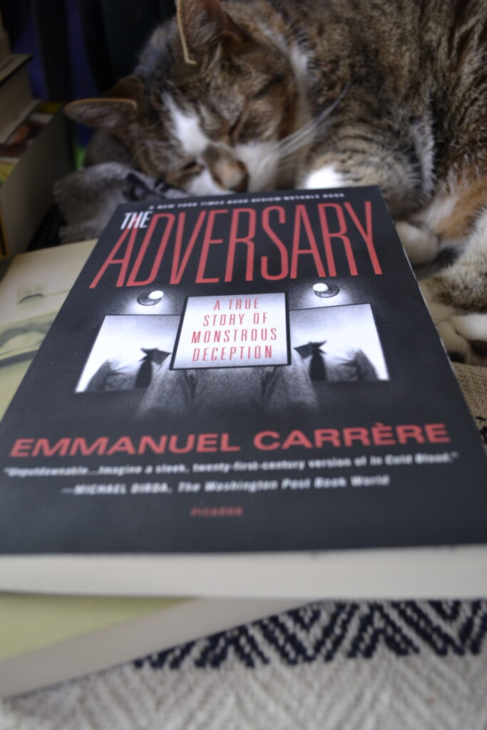 The Adversary: A True Story of Monstrous Deception features a black and white covers with images of a man whose head is occluded by text and search lights that look like eyes.