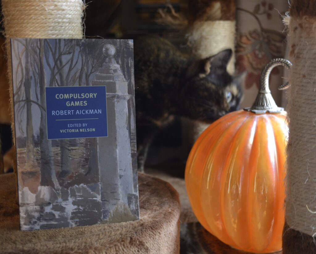 Compulsory Games by Robert Aickman is a softcover book with a painting of a graveyard as a cover image.