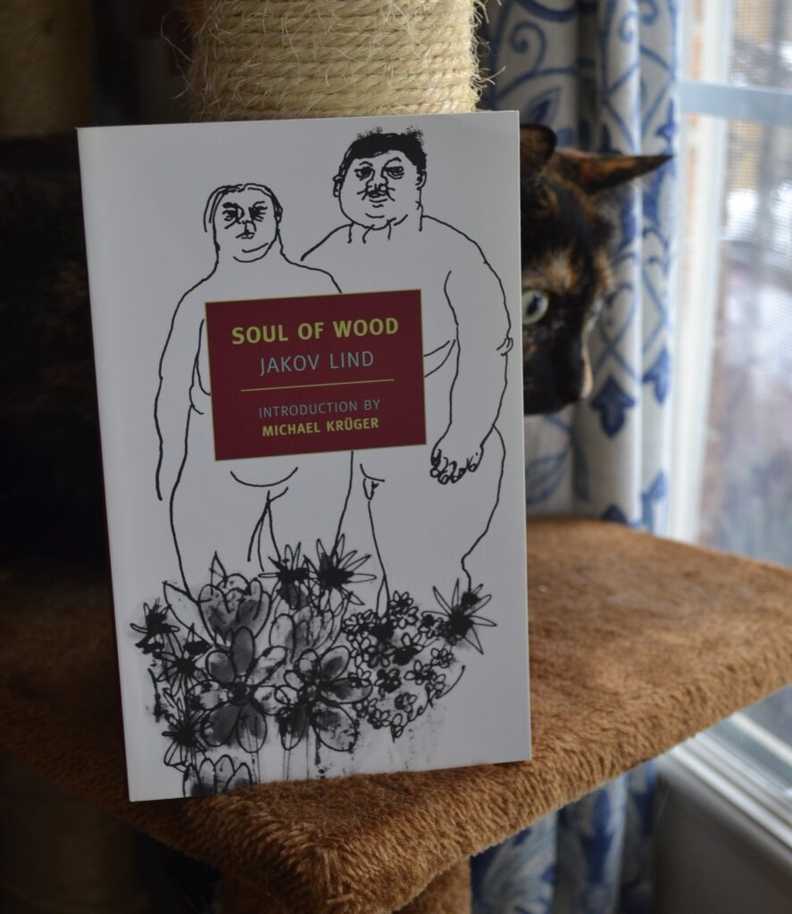 Soul of Wood by Jakov Lind features a drawing of a naked woman and man with flowers. A tortoiseshell cat crouches wide-eyed behind it.