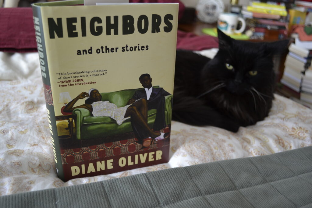 Neighbors and Other Stories by Diane Oliver is a hardcover book. The cover features a picture of a Black man in a suit and a Black woman in a white dress sitting on an olive green sofa.