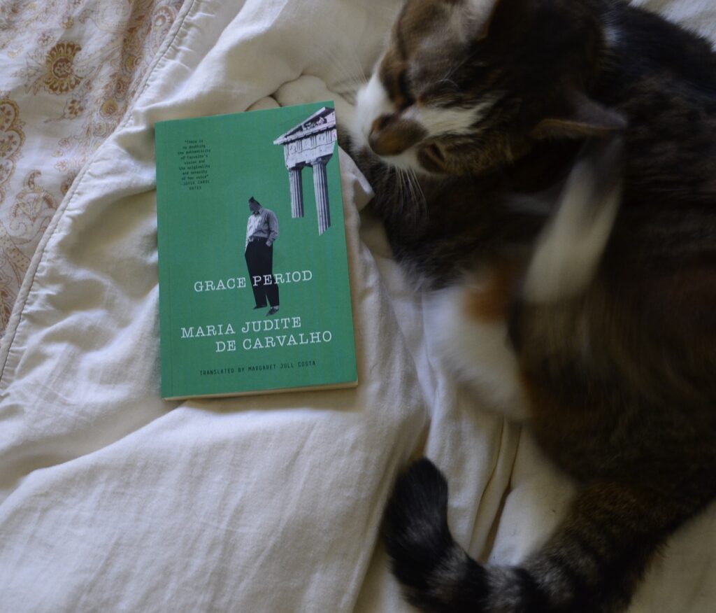 Grace Period by Maria Judite de Carvalho is a green book with cut-off black-and-white photographs of a person and an ancient structure with columns.